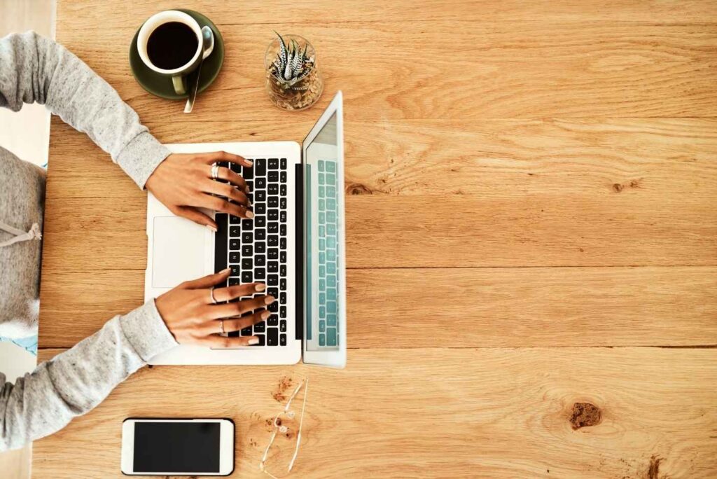 High angle shot of business woman sitting at desk indoors at laptop