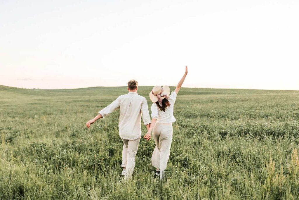 A couple walking on the grass field